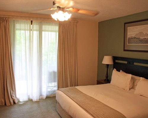 A well furnished bedroom with an outside view.