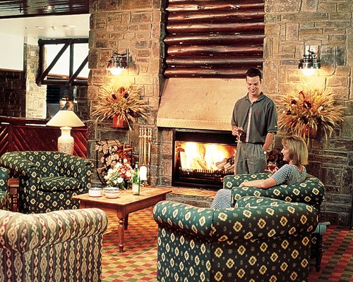 A well furnished living room with a fire in the fireplace.