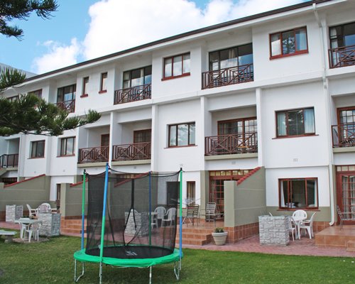 Scenic exterior view of multi story resort units with trampoline.