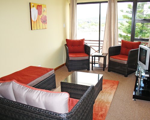 A well furnished living room with a television and outside view.
