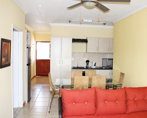 A well furnished living room with a dining area and open plan kitchen.