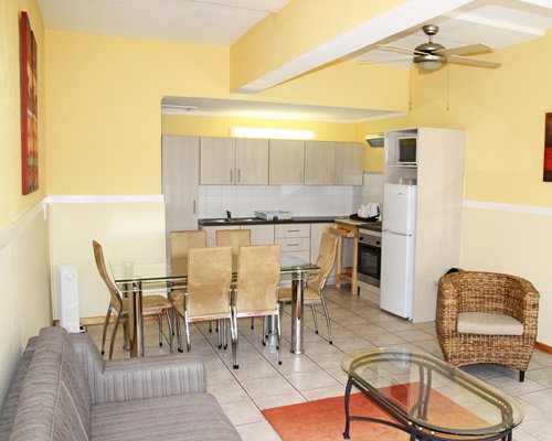 A well furnished living room with a dining area and open plan kitchen.