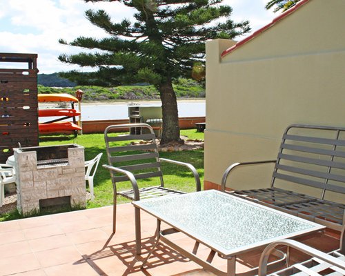 Patio with patio furniture alongside a waterfront.