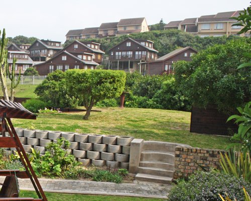 Scenic exterior view of units with a stairway at Kowie River Chalets resort.