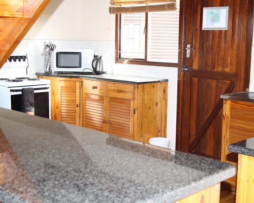 A well equipped kitchen with breakfast bar.