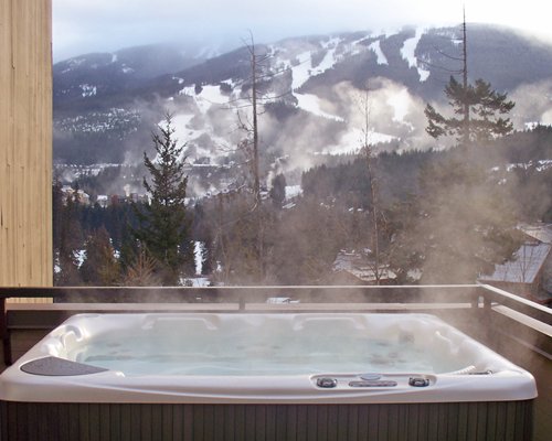 A hot tub with a view of the hills.