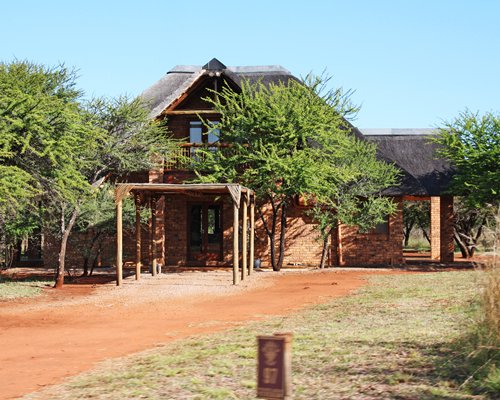 Pathway to a unit at Sondela Nature Reserve surrounded by wooded area.