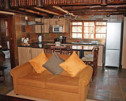 An open plan living dining and a kitchen area.