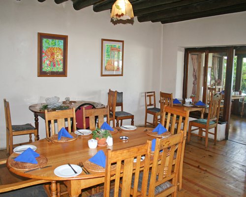 An indoor dining area with multiple dining tables.