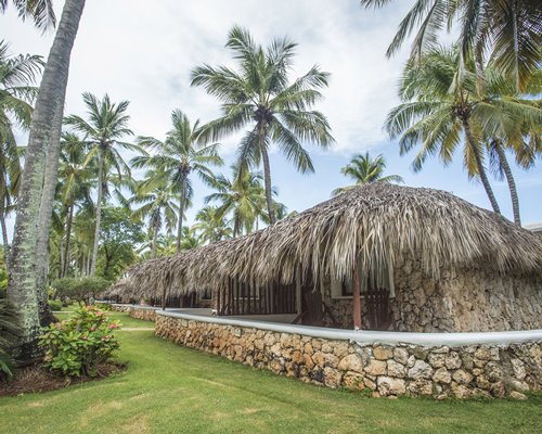 Scenic exterior view of resort units surrounded by coconut trees.