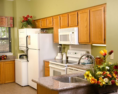 A well equipped kitchen with a microwave oven and a refrigerator.