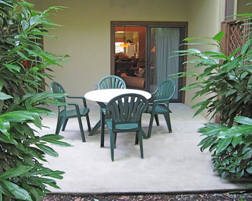 An exterior view of a resort unit with patio furniture.