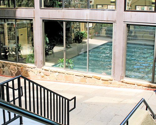 A view of indoor swimming pool alongside the staircase.