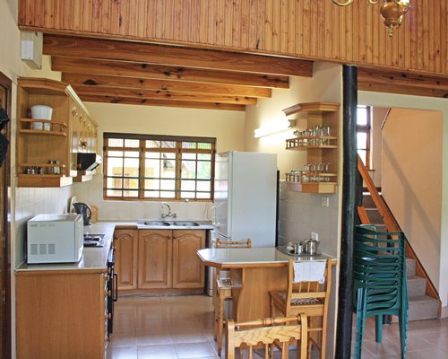An open plan kitchen and dining area alongside the staircase.