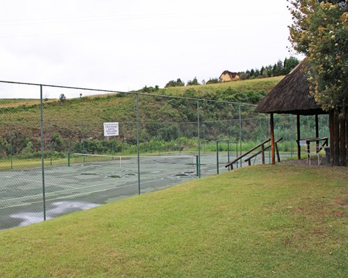 Outdoor recreation area with tennis court.