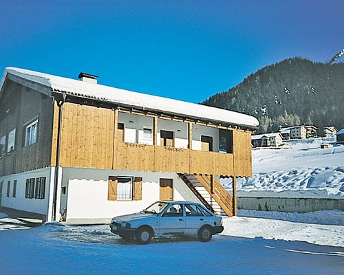 Casa Canazei alongside the base of the mountain during the winter.