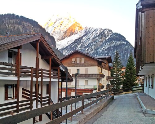 Exterior view of the pathway to Casa Canazei alongside mountains.