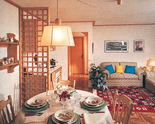 A well furnished living room with open plan kitchen and dining area.
