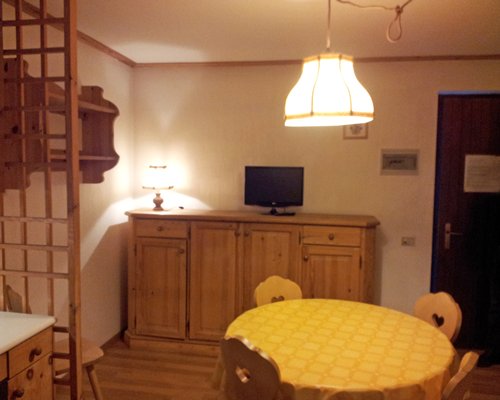 A well furnished living room with a dining area and television.