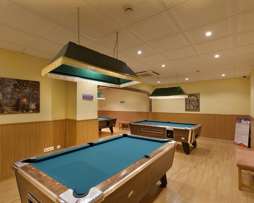 Indoor recreation room with pool tables.