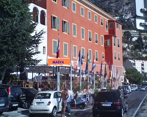 Street view of the multi story resort with the parking lot.