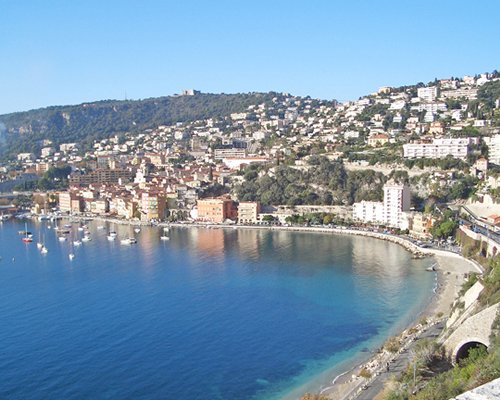 A view of the beach with sailboats alongside the multiple resorts.