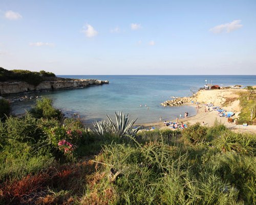 A beach view of people playing in the sea.