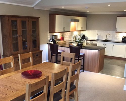 An open plan kitchen and dining area with a breakfast bar.