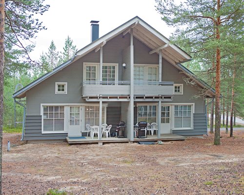 An exterior view of the vacation unit surrounded by wooded area.