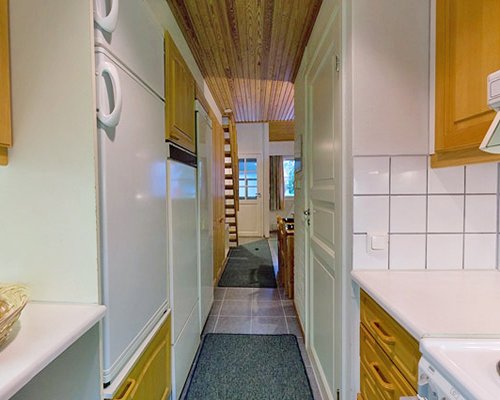 Interior pathway with an open plan kitchen and a stairway.