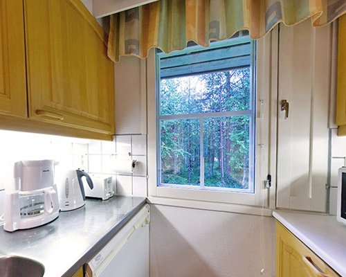 A well equipped kitchen with an outside view.