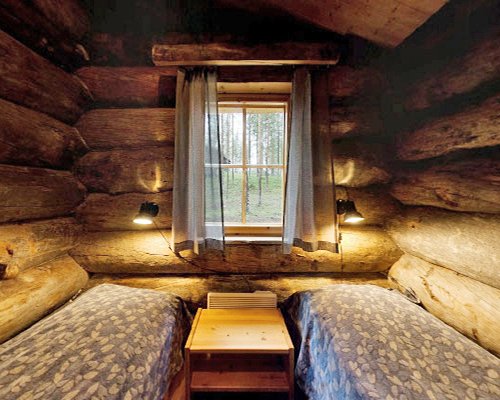 A well furnished bedroom with two beds and an outside view.