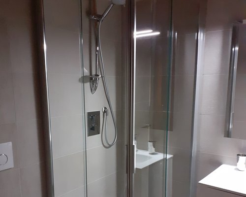 A bathroom with a bathtub and shower stall.