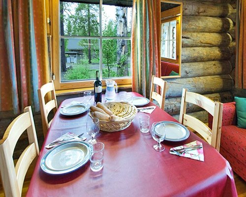 A view of the wooden dining table with an outside view.
