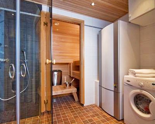 A bathroom with a shower stall and sauna.