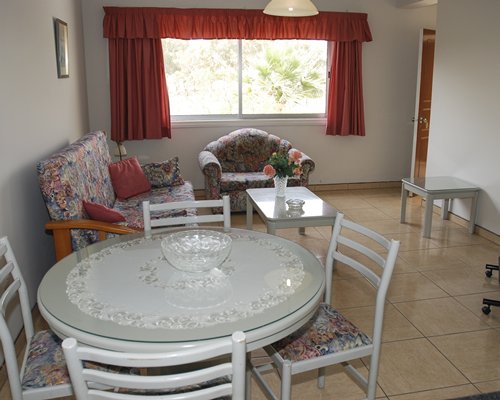 A well furnished living and dining area with an outside view.