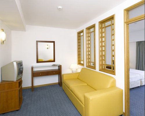 A well furnished living room with a television and a vanity.