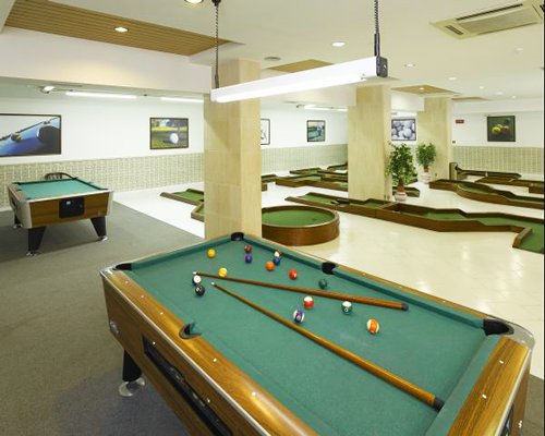 An indoor recreation room with pool tables.