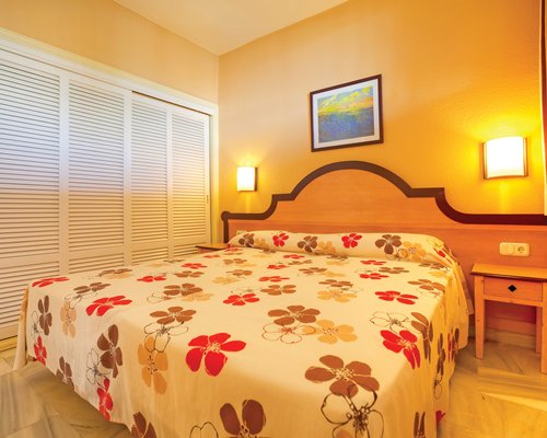 A well furnished bedroom with a double bed.