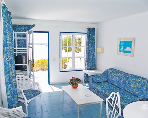A well furnished living room with a television and a pull out sofa.