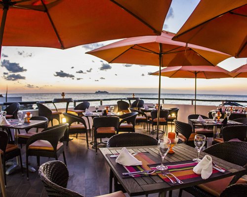 An outdoor fine dining restaurant facing the ocean.