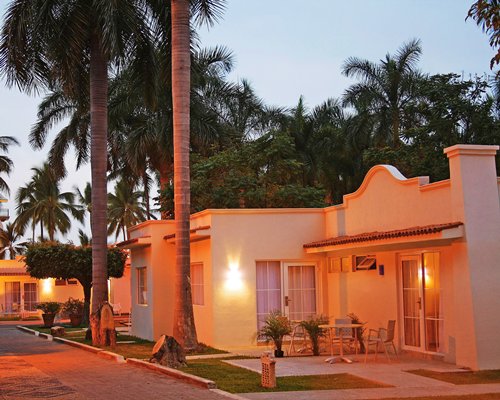 A street view of multiple Krystal International Vacation Club at dusk.