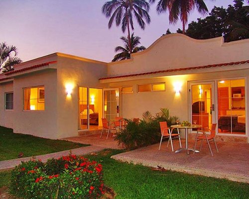 Exterior view of Krystal International Vacation Club resort at dusk.