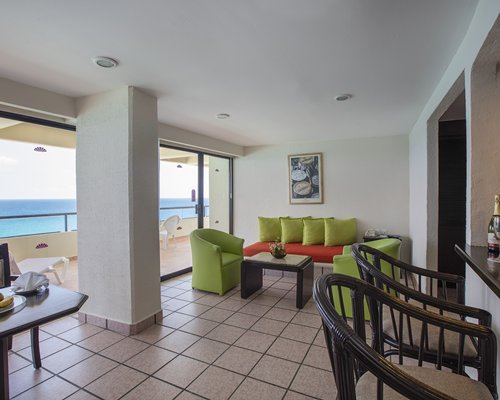 An open plan living dining area with a balcony.