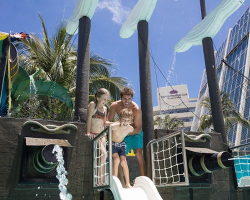 A family enjoying in a water slide.