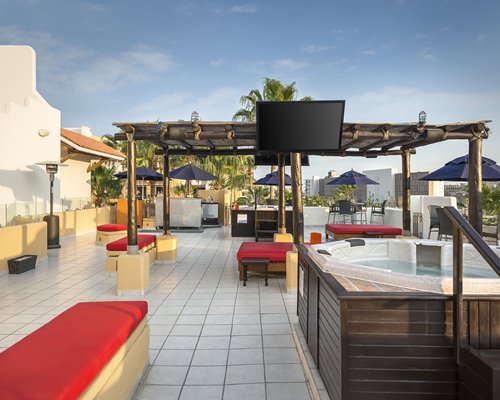 An outdoor swimming pool with chaise lounge chairs.