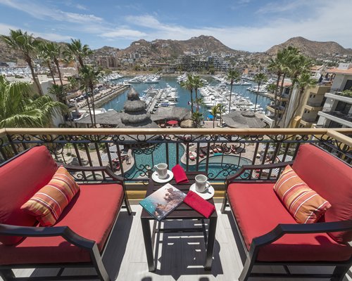An outdoor swimming pool with chaise lounge chairs alongside the resort units.