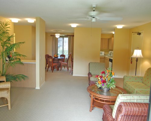 A well furnished living room with an open plan kitchen and dining area.