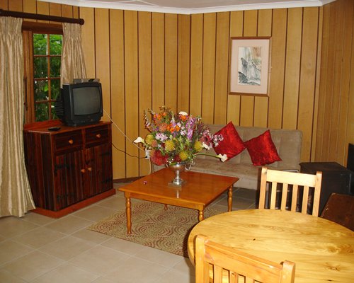 An open plan living and dining area with television.