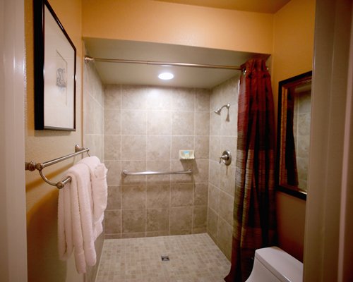 A bathroom with a standing shower and vanity.